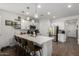 Modern kitchen featuring a quartz countertop island with bar stool seating and stainless appliances at 5712 S Parkwood --, Mesa, AZ 85212