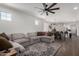 Spacious living room with a large sectional couch, ceiling fan and hardwood flooring at 5712 S Parkwood --, Mesa, AZ 85212