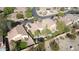 Aerial view of homes with backyard pools and lush landscaping, with solar panels on one home at 6071 S Topaz Pl, Chandler, AZ 85249