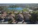 Beautiful aerial view showcasing the community lake and three homes with well-maintained landscaping at 6071 S Topaz Pl, Chandler, AZ 85249