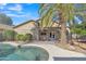 Lush backyard featuring a pool, covered patio, palm tree and mature desert landscaping at 6071 S Topaz Pl, Chandler, AZ 85249