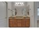 Bathroom features dual sinks with stylish vessel sinks, a granite countertop, and decorative mirrors at 6071 S Topaz Pl, Chandler, AZ 85249