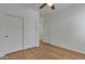 Bedroom features wood-look flooring, a ceiling fan and a closet with sliding doors at 6071 S Topaz Pl, Chandler, AZ 85249