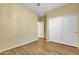 This bedroom offers wood-look flooring, a ceiling fan, and a closet with sliding doors at 6071 S Topaz Pl, Chandler, AZ 85249