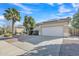 Inviting single-story house with a two-car garage, desert landscaping, and a mature palm tree in the yard at 6071 S Topaz Pl, Chandler, AZ 85249