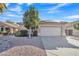 Well-kept house featuring a two-car garage, desert landscaping, and a beautiful tree in the front yard at 6071 S Topaz Pl, Chandler, AZ 85249