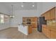 Open concept kitchen with an island, granite countertops, tile backsplash, wooden cabinetry, and stainless steel appliances at 6071 S Topaz Pl, Chandler, AZ 85249