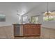 Kitchen island featuring a stainless steel dishwasher, sink, and dark hardware at 6071 S Topaz Pl, Chandler, AZ 85249