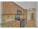 Kitchen showcasing granite countertops, wooden cabinetry, tile backsplash, and stainless steel appliances at 6071 S Topaz Pl, Chandler, AZ 85249
