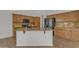 Well-lit kitchen with an island, granite countertops, tile backsplash, wooden cabinetry, and stainless steel appliances at 6071 S Topaz Pl, Chandler, AZ 85249