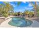 Backyard pool with a built-in spa surrounded by lush landscaping and palm trees at 6071 S Topaz Pl, Chandler, AZ 85249