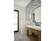 Chic powder room featuring mosaic tile, a rustic wood vanity, and modern fixtures at 6147 E Desert Cove Ave, Scottsdale, AZ 85254