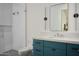 Bathroom with walk-in shower, blue vanity, and marble countertop at 6147 E Desert Cove Ave, Scottsdale, AZ 85254