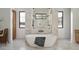 Bright bathroom features a freestanding tub, marble surround, and sleek black fixtures at 6147 E Desert Cove Ave, Scottsdale, AZ 85254