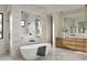 Luxurious bathroom showcasing a freestanding tub, walk-in shower, and modern wood vanity at 6147 E Desert Cove Ave, Scottsdale, AZ 85254
