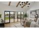 Bright bedroom with expansive windows, wood beam ceiling, and stylish decor at 6147 E Desert Cove Ave, Scottsdale, AZ 85254