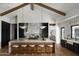 Spacious kitchen boasts a large island with seating, modern appliances, and beautiful marble countertops at 6147 E Desert Cove Ave, Scottsdale, AZ 85254
