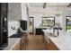 Bright kitchen features a marble island with dual sinks, stainless steel appliances, and stylish light fixtures at 6147 E Desert Cove Ave, Scottsdale, AZ 85254