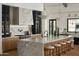 Modern kitchen with an oversized marble island with seating, state-of-the-art appliances, and designer finishes at 6147 E Desert Cove Ave, Scottsdale, AZ 85254