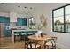 Kitchen with a breakfast bar, blue cabinets, stainless appliances, and wood flooring at 6147 E Desert Cove Ave, Scottsdale, AZ 85254