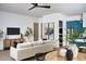 Living room with sofa, art, and dining table, showcasing open layout to kitchen at 6147 E Desert Cove Ave, Scottsdale, AZ 85254