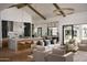 Bright and airy living room open to the kitchen, featuring high ceilings, exposed beams, and stylish furnishings at 6147 E Desert Cove Ave, Scottsdale, AZ 85254