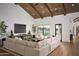 Open-concept living room featuring high ceilings, a large sectional sofa, and expansive windows at 6147 E Desert Cove Ave, Scottsdale, AZ 85254