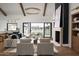 Well-lit living room with a view to the pool area, comfortable seating, and a cozy fireplace at 6147 E Desert Cove Ave, Scottsdale, AZ 85254
