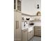 Pantry area boasts custom cabinets, open shelving, sleek countertops, and a farmhouse sink at 6147 E Desert Cove Ave, Scottsdale, AZ 85254