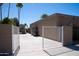 Fully fenced backyard with white gates and a concrete patio at 6529 E Voltaire Ave, Scottsdale, AZ 85254