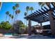 Spacious backyard showcasing a pool, pergola covered patio, and well-manicured landscaping at 6529 E Voltaire Ave, Scottsdale, AZ 85254
