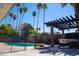Inviting backyard featuring a sparkling pool, covered patio, pergola and lush landscaping at 6529 E Voltaire Ave, Scottsdale, AZ 85254