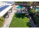 Aerial view of a backyard with a grassy lawn, patio, and solar panels at 6529 E Voltaire Ave, Scottsdale, AZ 85254