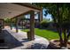 Covered patio view overlooking a lush lawn, mature trees, and a pool at 6529 E Voltaire Ave, Scottsdale, AZ 85254