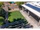 Aerial view of backyard featuring lawn, solar panels, and shade structure at 6529 E Voltaire Ave, Scottsdale, AZ 85254