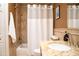 Bathroom featuring a shower-tub combo, white shower curtain, and granite countertop at 6529 E Voltaire Ave, Scottsdale, AZ 85254
