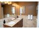 Bathroom featuring double sinks, granite countertops, and stylish lighting fixtures at 6529 E Voltaire Ave, Scottsdale, AZ 85254