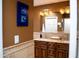 Bathroom featuring double sinks, granite countertops, and stylish lighting fixtures at 6529 E Voltaire Ave, Scottsdale, AZ 85254