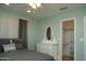 A cozy bedroom features an arched window, neutral tones, and an attached closet for convenience at 6529 E Voltaire Ave, Scottsdale, AZ 85254