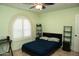 Bedroom with neutral accents, a arched window with plantation shutters and plenty of natural light at 6529 E Voltaire Ave, Scottsdale, AZ 85254