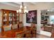 Open-concept dining room with traditional wood furniture and views to the kitchen at 6529 E Voltaire Ave, Scottsdale, AZ 85254