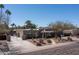 Inviting single-story house with a charming brick exterior, desert landscaping, and a private gated entry at 6529 E Voltaire Ave, Scottsdale, AZ 85254