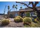Charming home with beautiful barrel cactus landscaping, a tiled roof, and decorative arch windows at 6529 E Voltaire Ave, Scottsdale, AZ 85254