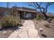 Inviting home features a stone walkway, desert plants, and a charming desert-style landscape at 6529 E Voltaire Ave, Scottsdale, AZ 85254