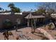 Beautiful home featuring rock landscaping, a stone walkway, and charming desert plants at 6529 E Voltaire Ave, Scottsdale, AZ 85254