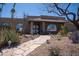 Charming single-story home featuring a stone walkway and low-maintenance desert landscaping at 6529 E Voltaire Ave, Scottsdale, AZ 85254