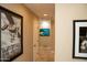 Narrow hallway with art and natural light to the left and right at 6529 E Voltaire Ave, Scottsdale, AZ 85254