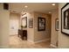 Bright hallway with skylight and a view of the front door and artwork at 6529 E Voltaire Ave, Scottsdale, AZ 85254