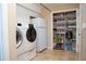 Laundry room with white washer and dryer next to fridge and pantry at 6529 E Voltaire Ave, Scottsdale, AZ 85254
