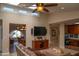 Relaxing living room with a ceiling fan, skylights, and easy access to the dining area at 6529 E Voltaire Ave, Scottsdale, AZ 85254